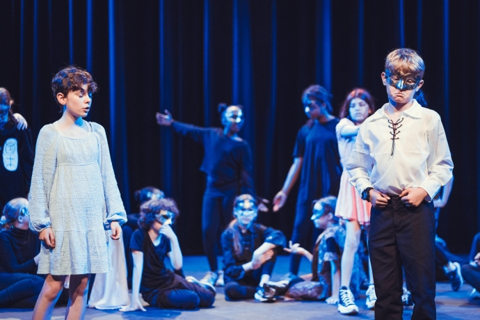 Young people acting on stage in costume