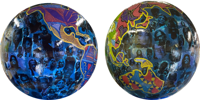 Two globe art sculptures with images of Black Britons on them. 